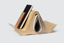 Load image into Gallery viewer, Isokon Gull oblique view with newspaper on side on notebooks on one side
